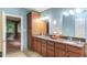 The bathroom has dual sinks with a vanity, as well as a storage cabinet at 3833 Hidden Branches Dr, Raleigh, NC 27613