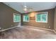This spacious bedroom has multiple windows and a ceiling fan at 3833 Hidden Branches Dr, Raleigh, NC 27613