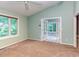 The bedroom has a ceiling fan, carpeted floor, and opens to a sunroom at 3833 Hidden Branches Dr, Raleigh, NC 27613