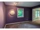 Spacious bedroom with an eye-catching accent wall, great lighting, and double doors leading to another room at 3833 Hidden Branches Dr, Raleigh, NC 27613