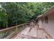 Wooden deck overlooking lush trees provides a serene setting, blending seamlessly with nature at 3833 Hidden Branches Dr, Raleigh, NC 27613