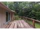 Expansive wooden deck offers views of the surrounding lush greenery, ideal for outdoor relaxation and entertaining at 3833 Hidden Branches Dr, Raleigh, NC 27613