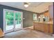Bright dining area featuring a ceiling fan, deck access, and open layout to the kitchen at 3833 Hidden Branches Dr, Raleigh, NC 27613
