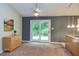 Inviting dining area featuring sliding glass doors to the deck, a ceiling fan, and convenient access to the kitchen at 3833 Hidden Branches Dr, Raleigh, NC 27613