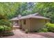 Charming home featuring an inviting walkway, wood siding, and lush landscaping at 3833 Hidden Branches Dr, Raleigh, NC 27613