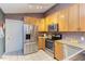 Well-equipped kitchen with stainless steel appliances, light wood cabinets, and sleek countertops at 3833 Hidden Branches Dr, Raleigh, NC 27613