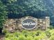 Stone sign showcasing the Sandy Chase community, surrounded by greenery at 3833 Hidden Branches Dr, Raleigh, NC 27613