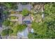 An aerial view of a home with solar panels on the roof, surrounded by mature trees and lush landscaping at 414 W Markham Ave, Durham, NC 27701