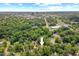 An aerial view of a home surrounded by trees and landscape with downtown city skyline in the distance at 414 W Markham Ave, Durham, NC 27701