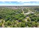An aerial view of a home surrounded by trees and landscape with downtown city skyline in the distance at 414 W Markham Ave, Durham, NC 27701