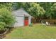 Spacious backyard with storage shed, mature trees, and seating area at 414 W Markham Ave, Durham, NC 27701