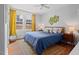 Sunlit bedroom featuring hardwood floors, bright windows and blue bedding at 414 W Markham Ave, Durham, NC 27701