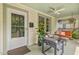 Relaxing front porch featuring a porch swing, ceiling fan, and comfortable seating at 414 W Markham Ave, Durham, NC 27701