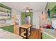 Kitchen with stainless steel appliances, green cabinetry, butcher block island and hardwood floors at 414 W Markham Ave, Durham, NC 27701