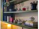 Well-decorated kitchen shelves featuring glassware, plants and design books at 414 W Markham Ave, Durham, NC 27701
