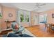 Bright living room featuring hardwood floors, a cozy sitting area, and natural light at 414 W Markham Ave, Durham, NC 27701