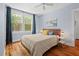 Comfortable bedroom with hardwood floors and a large window at 414 W Markham Ave, Durham, NC 27701