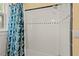 Bright shower with white tiled walls and a classic shower curtain at 414 W Markham Ave, Durham, NC 27701