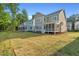 Newly sodded backyard with screened in porches and green trees in the background at 414 Wyndham Dr, Chapel Hill, NC 27516