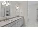 Modern bathroom with double sink vanity, white cabinetry, and marble tile floors and a glass shower stall at 414 Wyndham Dr, Chapel Hill, NC 27516