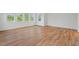 Spacious room featuring hardwood flooring, multiple windows providing natural light, and a neutral color palette at 414 Wyndham Dr, Chapel Hill, NC 27516