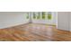Room with hardwood flooring and large windows offering views of the outdoors, creating a bright and airy atmosphere at 414 Wyndham Dr, Chapel Hill, NC 27516