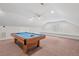 Bright bonus room showing the pool table with storage in the attic and a large area with bench seating at 414 Wyndham Dr, Chapel Hill, NC 27516