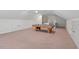 Spacious bonus room features neutral carpet, pool table, and ample storage with attic access at 414 Wyndham Dr, Chapel Hill, NC 27516