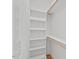 Walk-in closet complete with built in shelving and wood support beams for hanging clothes at 414 Wyndham Dr, Chapel Hill, NC 27516