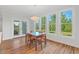 Dining room featuring hardwood floors, and multiple windows that provide ample natural light and green views at 414 Wyndham Dr, Chapel Hill, NC 27516