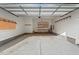 Spacious two car garage with shelving for storage and painted cinder block foundation at 414 Wyndham Dr, Chapel Hill, NC 27516