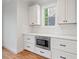 Beautiful kitchen featuring white cabinets, drawers, stainless steel microwave, and white subway tile backsplash at 414 Wyndham Dr, Chapel Hill, NC 27516