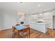 Open kitchen and dining area with stainless steel appliances and an island at 414 Wyndham Dr, Chapel Hill, NC 27516