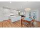 Open floorplan of the kitchen, dining room, and living room with white cabinets and stainless steel appliances at 414 Wyndham Dr, Chapel Hill, NC 27516
