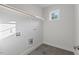 Bright laundry room has gray tile flooring, a hanging rack, and natural light from the window at 414 Wyndham Dr, Chapel Hill, NC 27516