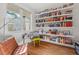 Bright office space with custom shelving, a comfortable chair, and lots of natural light at 414 Wyndham Dr, Chapel Hill, NC 27516