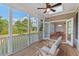 Cozy screened-in porch with wooden floors and comfortable seating overlooking the green backyard at 414 Wyndham Dr, Chapel Hill, NC 27516