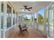 Relaxing screened-in porch with wooden floors, ceiling fan, and comfortable seating overlooking the backyard at 414 Wyndham Dr, Chapel Hill, NC 27516