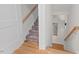 A carpeted stairway with wood handrails leads to an open floorplan with hardwood floors at 414 Wyndham Dr, Chapel Hill, NC 27516