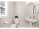 Bright powder room with a pedestal sink, toilet, and modern fixtures at 442 Granite Mill Blvd, Chapel Hill, NC 27516