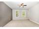 Bedroom featuring two large windows and a neutral, cozy carpet at 442 Granite Mill Blvd, Chapel Hill, NC 27516