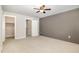 Spacious bedroom features a walk-in closet, neutral carpet, ceiling fan and stylish accent wall at 442 Granite Mill Blvd, Chapel Hill, NC 27516