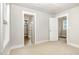 Bright bedroom featuring neutral carpet with views of the hall and closets at 442 Granite Mill Blvd, Chapel Hill, NC 27516
