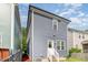 Rear exterior view of home with grey siding, white trim, and a small back yard at 442 Granite Mill Blvd, Chapel Hill, NC 27516