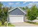 Attached two car garage with white door and blue siding at 442 Granite Mill Blvd, Chapel Hill, NC 27516