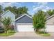 Attached two car garage with white door, blue siding, and well-manicured lawn at 442 Granite Mill Blvd, Chapel Hill, NC 27516