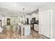 Modern kitchen with stainless steel appliances, granite countertops, and an open layout to the living area at 442 Granite Mill Blvd, Chapel Hill, NC 27516
