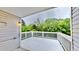 View of the white painted back deck with white railing overlooking trees and landscape at 4736 Walden Pond Dr, Raleigh, NC 27604