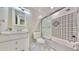 Bathroom featuring decorative tile in shower and white vanity with marble floors at 4736 Walden Pond Dr, Raleigh, NC 27604