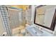 Well-lit bathroom featuring patterned tile in the shower and vanity with a dark framed mirror at 4736 Walden Pond Dr, Raleigh, NC 27604
